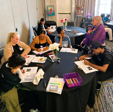 Participants drawing together at a workshop table
