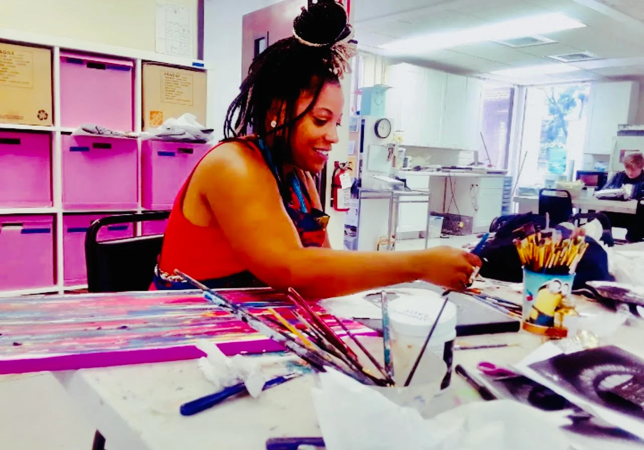Jay Boyer painting at a worktable